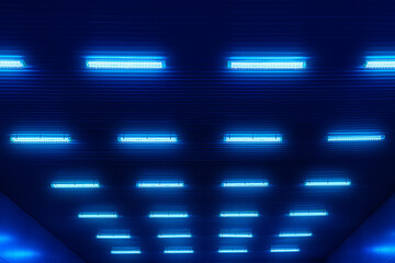 Abstract futuristic background. Blue glow from electric lamps. Neon light on dark background. Fluorescent ceiling lamps