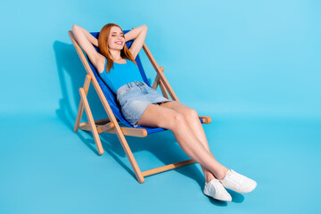 Portrait of attractive dreamy cheerful girl sitting in chair pool party rest isolated over bright...