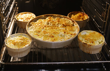 Homemade creamy Au Gratin Potatoes in oven.