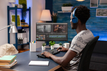 African american editor retouching video montage editing visual effects for movie project on...