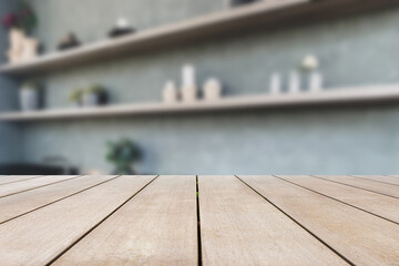 Empty old wooden table top and blurred wall shelves are decorated with loft style decorations in the condominium background. Can be used for display or montage for show your products.