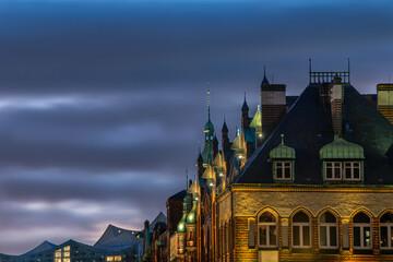 Detailed and high dynamic photography of the roofs in the illuminated Speicherstadt in Hamburg at the early blue hour