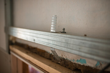 The worker installed a metal profile of the wall. Metal profiles. Metal material for building walls.