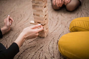 Fototapeta na wymiar play ginga with a friend. Business team is trying to generate new ideas with wooden bricks. Business risk concept. Wooden blocks are stacked in a tall tower.