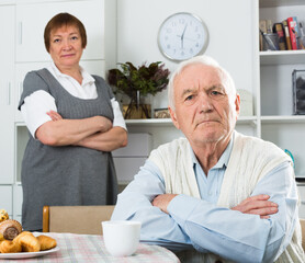 Old couple quarreled and offended at each other at table at home
