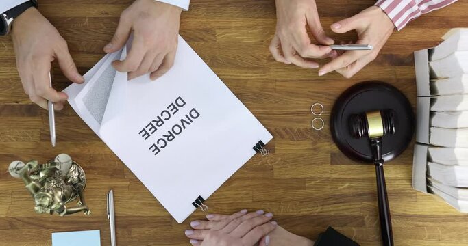 Judge submits documents with court decision on divorce to married couple for signature