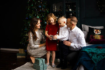 Family Christmas at home. Happy parents and their chilfren daughter and son waiting for Christmas at home.