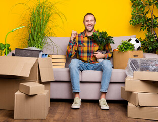 Photo of astonished funny guy prepare relocate rejoice new room wear checkered shirt isolated...