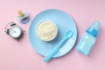 Concept of baby food with рowdered milk on pink background