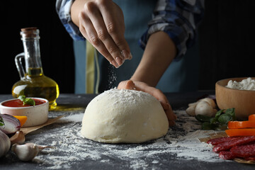 Concept of cooking pizza on dark textured table