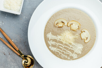 mushroom cream soup with parmesan and fried mushroom slices. Food recipe background. Close up