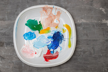 white plastic plate with acrylic dry paint