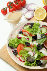 Concept of tasty food with vegetable salad with tahini sauce on white background
