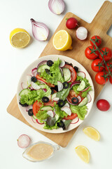 Concept of tasty food with vegetable salad with tahini sauce on white background