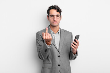 hispanic handsome man feeling angry, annoyed, rebellious and aggressive. business and phone concept