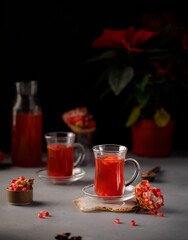 Hot turkish pomegranate tea with seeds, anise vertical photo. Vitamin nutrition beverage. Copy...