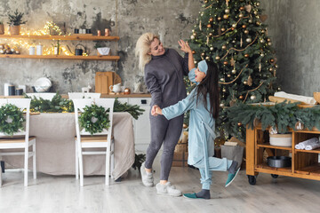 family, children, christmas, x-mas and happy people concept - hugging mother and daughter