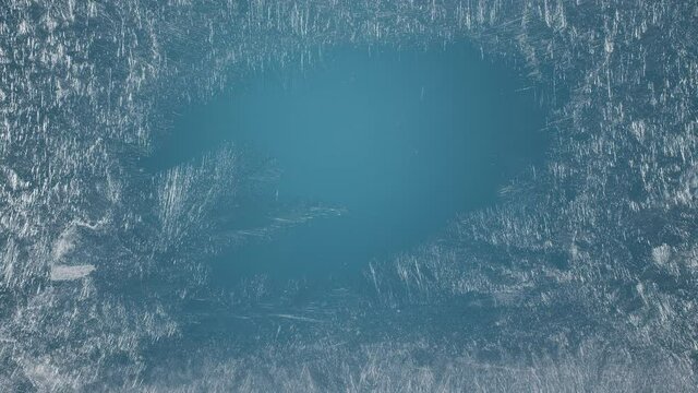 Frozen window with frosty patterns gradually fills with frost over its entire surface. Great background for Christmas and New Years. 