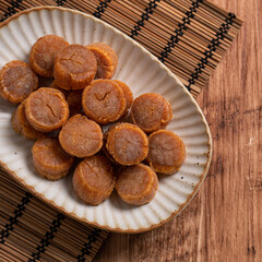Dried scallop on wooden table.