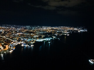 Lights of the night seaside city from a great height.
