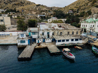 Fototapeta na wymiar An old pier in the quiet fishing harbor of the Black Sea.