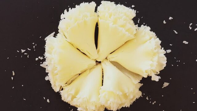 Swiss cheese Tete de Moine or monastery monk's head, scraped with a girolle special knife. Selective focus