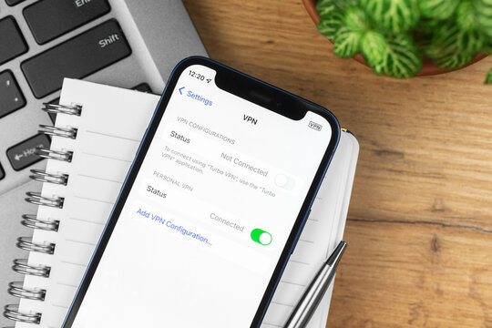 Kharkov, Ukraine - November 21, 2021: VPN Settings Screen On Apple IPhone. Business Workspace, Wooden Table, Top View Photo