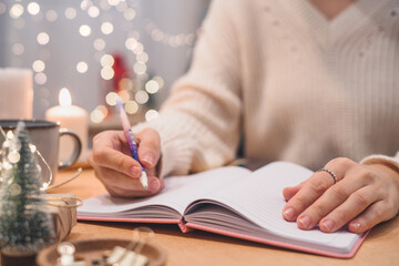 Goals plans make to do and wish list for new year christmas concept, girl writing in notebook....