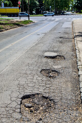 Holes in the asphalt road