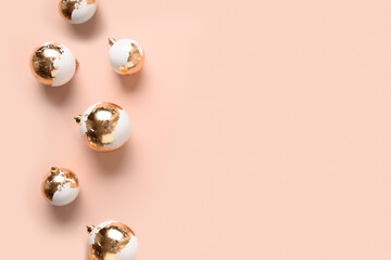 Christmas white baubles decorated gold potal on pink background. Xmas greeting card with copy space. Modern luxury metallic style.