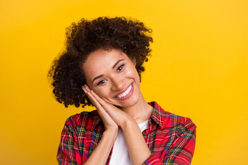 Portrait of attractive cheerful girl enjoying good mood pleasure isolated over bright yellow color...