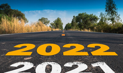 Message Year 2021 replaced by 2022 written on highway road in the middle of empty asphalt road...