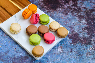 Selection of colorful french macaroons on   industrial background . Patisserie Banner