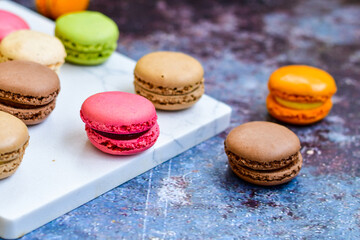 Selection of colorful french macaroons on   industrial background . Patisserie Banner
