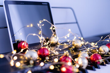 A colorful chain of lights lies on piano keys