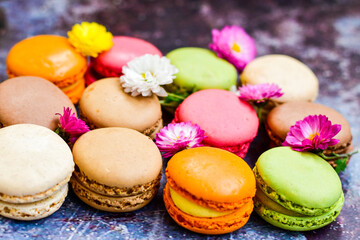 Fototapeta na wymiar Colorful french macaroons on wooden background