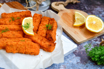  Fish and chips.Close up of crispy breaded  deep fried alaska pollock  fillets  with breadcrumbs served with remoulade sauce french fries  and  lemons