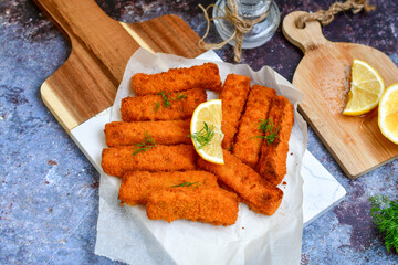  Fish and chips.Close up of crispy breaded  deep fried alaska pollock  fillets  with breadcrumbs served with remoulade sauce french fries  and  lemons