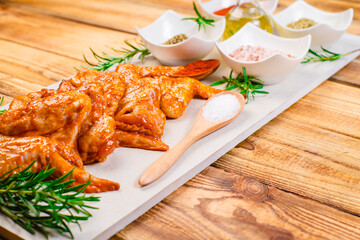 Oven baking wings. Chicken wings are raw in the marinade. Semifinished. Fast cooking.Raw Marinated chicken meat wings for BBQ,Cooking chicken with spices . Grilled chicken wings recipe.