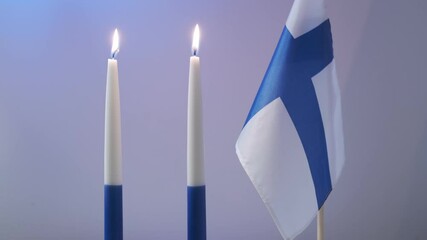 The traditional blue and white candles and flag of Finland