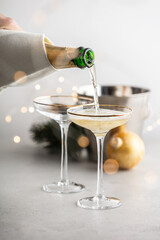 Champagne pouring into glasses and Christmas decorations