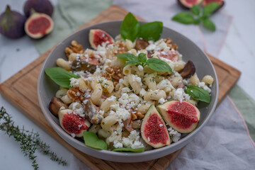pasta salad with figs and goat cheese on a table