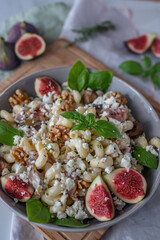 pasta salad with figs and goat cheese on a table