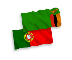 National vector fabric wave flags of Portugal and Republic of Zambia isolated on white background. 1 to 2 proportion.