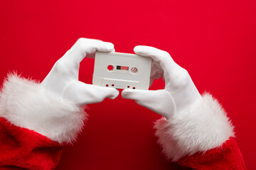 Father Christmas holding a retro music cassette tape. Christmas party concept