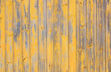 Old grey and yellow wooden background with cracks and scratches in vintage style
