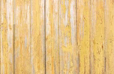 Obraz na płótnie Canvas Old grey and yellow wooden background with cracks and scratches in vintage style