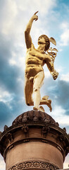 Stuttgart, Germany - Famous landmark: golden Hermes statue on a column near Schlossplatz against a...