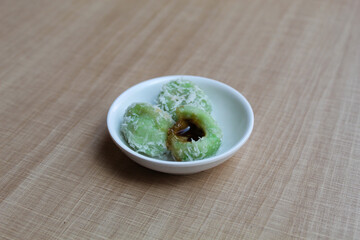 Klepon, is a traditional snack from Indonesia. Made from glutinous rice flour, filled with liquid palm sugar, sprinkled with grated coconut