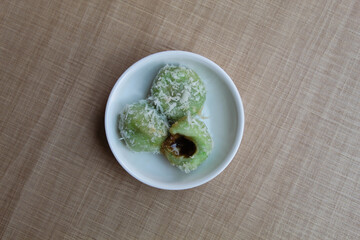 Klepon, is a traditional snack from Indonesia. Made from glutinous rice flour, filled with liquid palm sugar, sprinkled with grated coconut